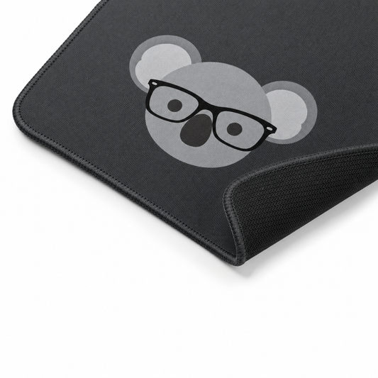 Corner detail of the desk mat showing the stitched edge and rubber underside